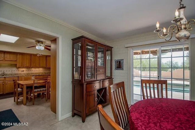 carpeted dining room with crown molding and ceiling fan with notable chandelier