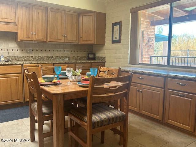 kitchen with light stone countertops and decorative backsplash