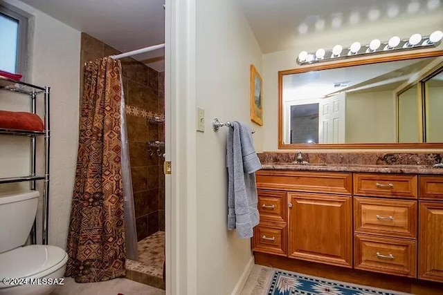 bathroom featuring tile patterned floors, a shower with curtain, vanity, and toilet