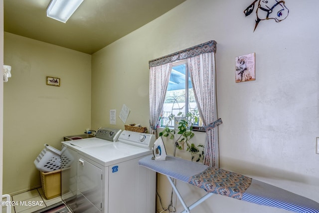 laundry room featuring washing machine and clothes dryer