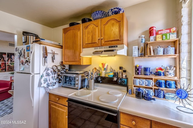 kitchen with electric stove, tile patterned floors, and white refrigerator