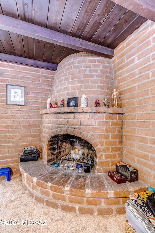 details with a large fireplace, wood ceiling, and beam ceiling