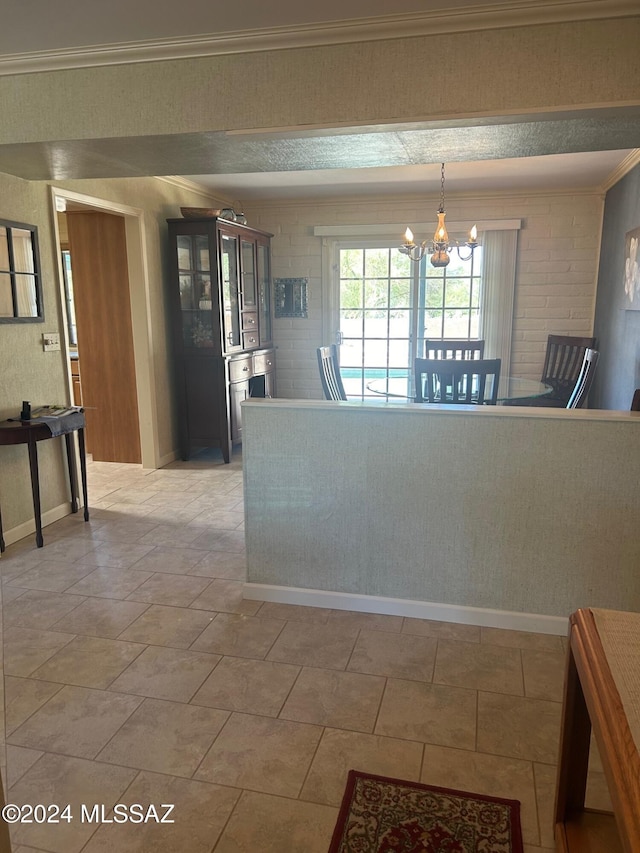 interior space with ornamental molding, brick wall, and an inviting chandelier