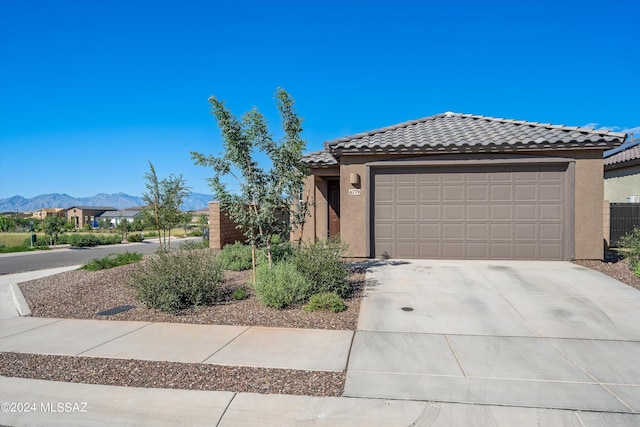 view of front of house with a garage and a mountain view