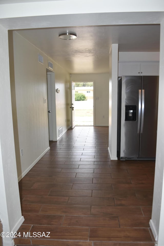 hallway with dark hardwood / wood-style floors