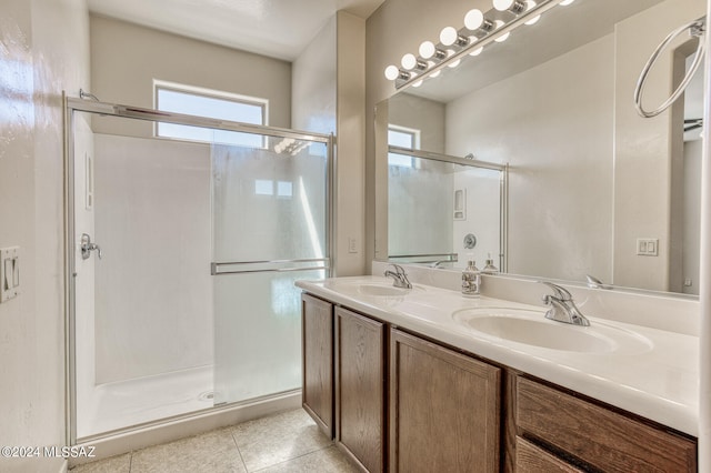 bathroom with tile patterned flooring, walk in shower, and vanity