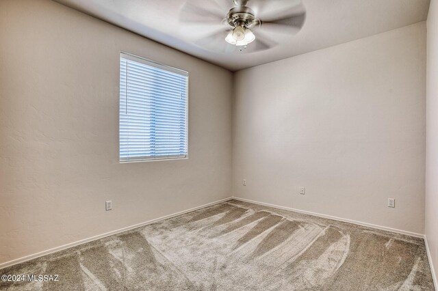 spare room featuring ceiling fan and carpet flooring