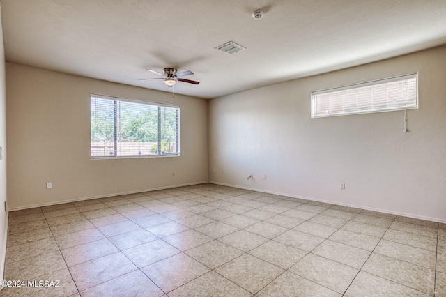 tiled empty room with ceiling fan