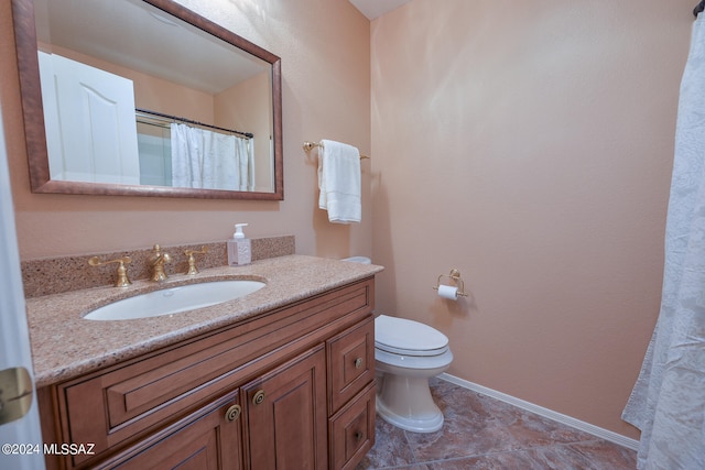 bathroom with tile patterned floors, vanity, and toilet