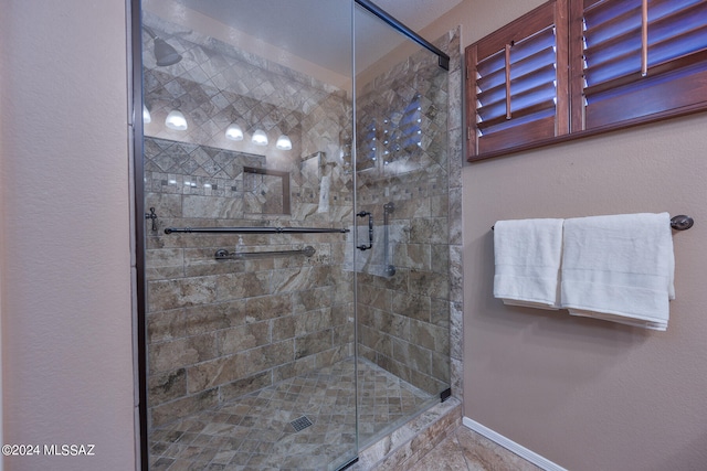 bathroom with a shower with door