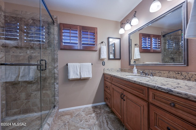 bathroom with vanity and a shower with door