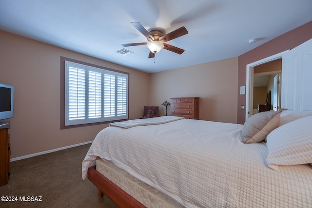 bedroom featuring dark carpet and ceiling fan