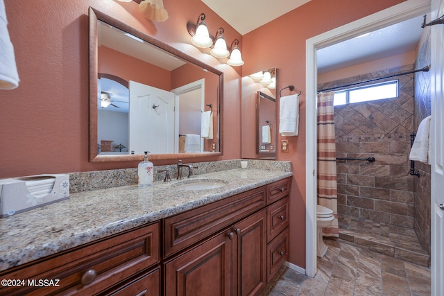 bathroom featuring ceiling fan, vanity, a shower with shower curtain, and toilet