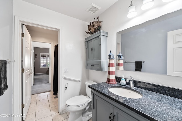 bathroom with tile patterned floors, vanity, and toilet