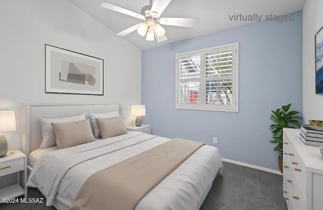 carpeted bedroom with vaulted ceiling and ceiling fan