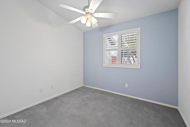 carpeted empty room featuring ceiling fan and lofted ceiling