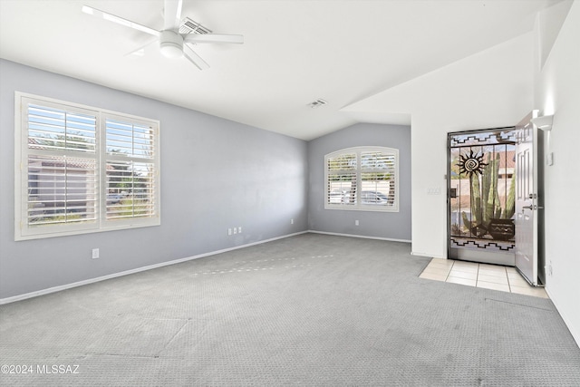 carpeted spare room with vaulted ceiling and ceiling fan