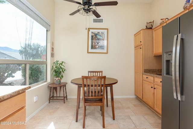 dining room featuring light tile patterned floors, ceiling fan, and a healthy amount of sunlight