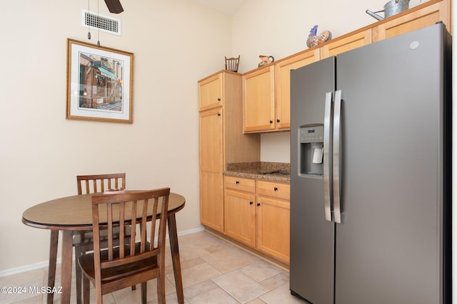 kitchen featuring ceiling fan, light brown cabinets, stainless steel fridge with ice dispenser, stone countertops, and light tile patterned floors