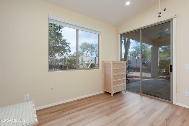 empty room featuring ceiling fan, light hardwood / wood-style floors, and vaulted ceiling