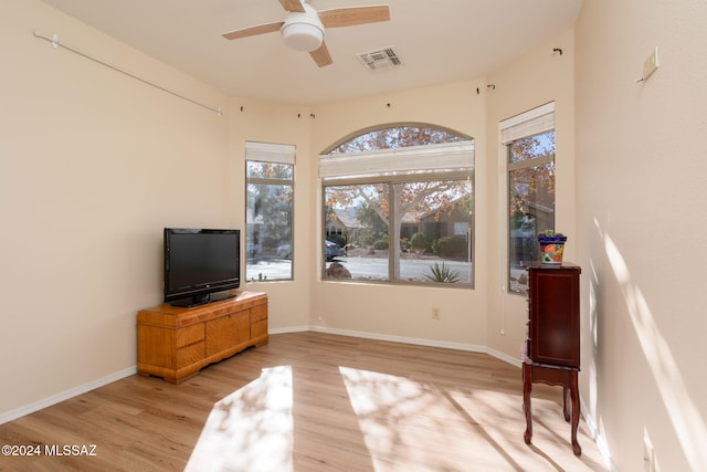 living area with light wood-type flooring and ceiling fan