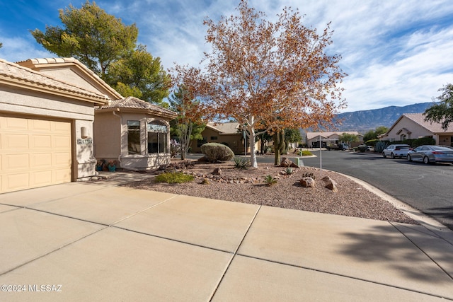 exterior space with a mountain view and a garage