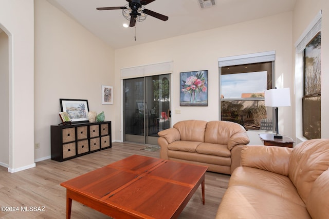 living room with ceiling fan and light hardwood / wood-style flooring