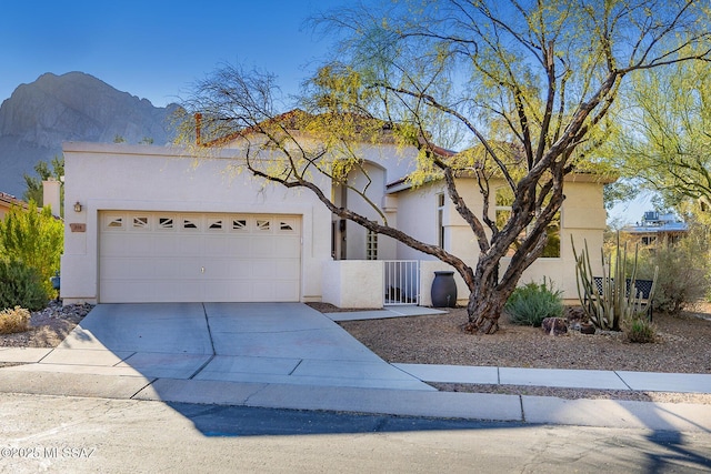 view of front of property with a garage and a mountain view