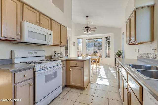 kitchen with light brown cabinetry, vaulted ceiling, light tile patterned floors, kitchen peninsula, and white appliances