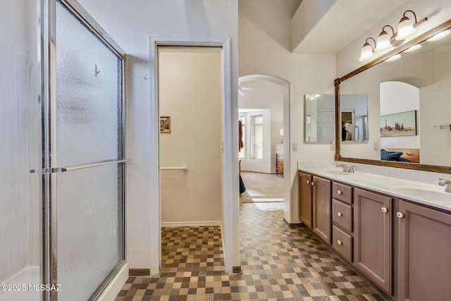 bathroom with a shower with door and vanity