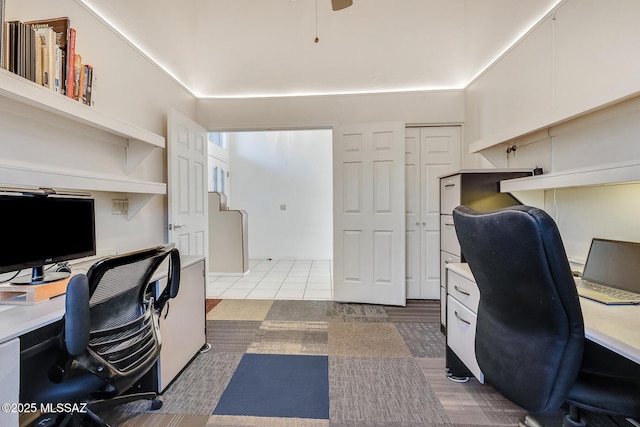 office area featuring ceiling fan and a high ceiling