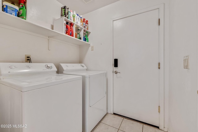 laundry area featuring separate washer and dryer and light tile patterned floors