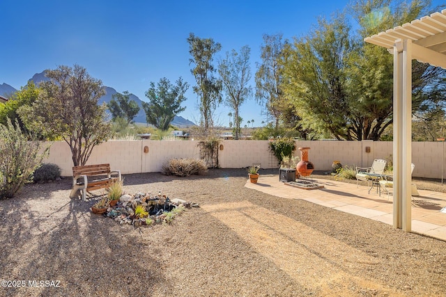 view of yard with a mountain view and a patio