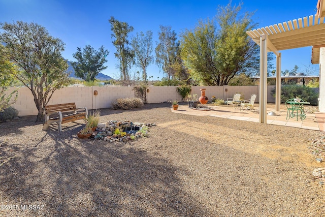 view of yard featuring a pergola, an outdoor fire pit, and a patio area