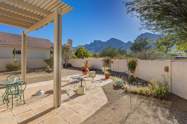 view of patio with a pergola and a mountain view