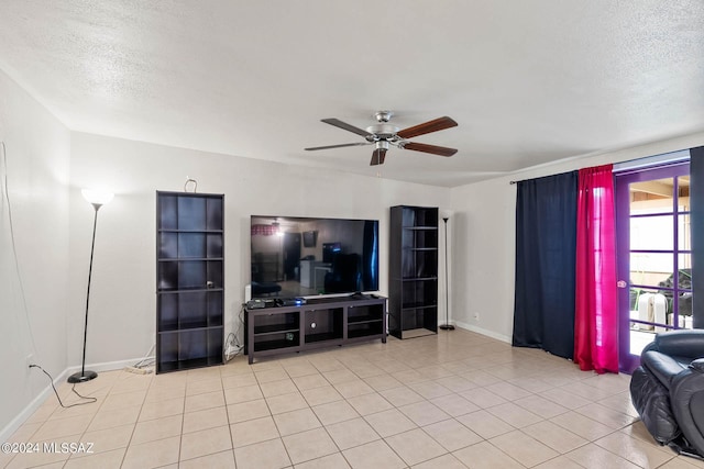 living area with baseboards, a textured ceiling, ceiling fan, and tile patterned flooring