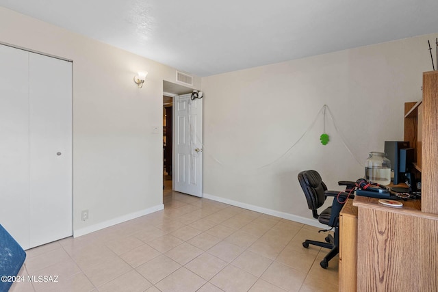 office featuring light tile patterned floors, baseboards, and visible vents