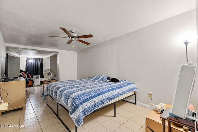 bedroom with ceiling fan and light tile patterned floors