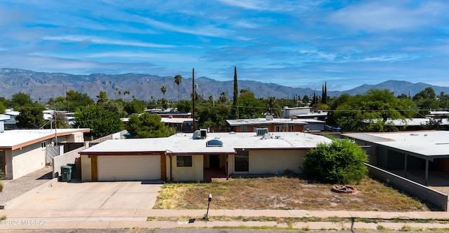 view of front of property featuring a mountain view, an attached garage, and concrete driveway