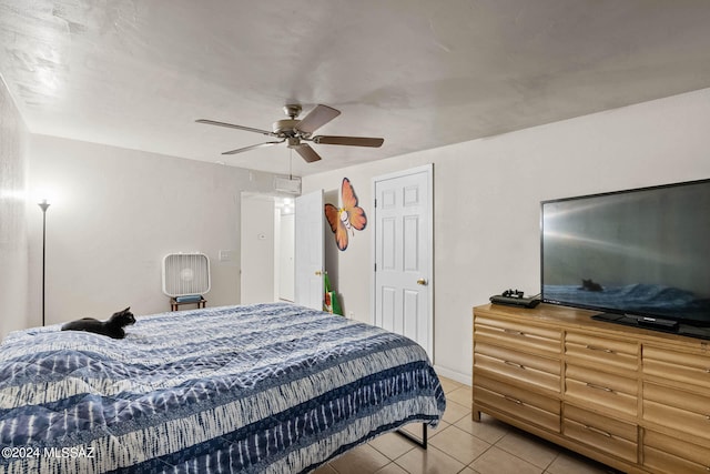 tiled bedroom featuring ceiling fan