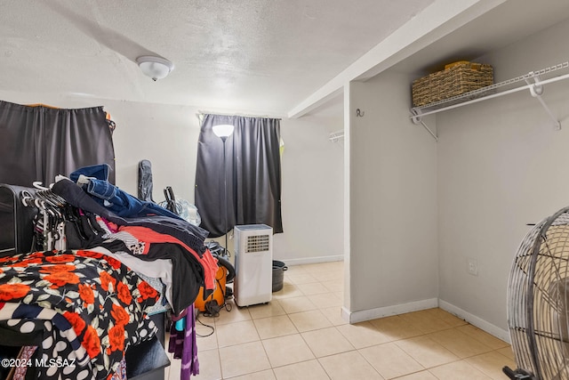 bedroom featuring a textured ceiling and light tile patterned floors