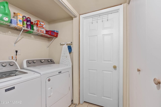 washroom with laundry area, washing machine and dryer, and light tile patterned flooring