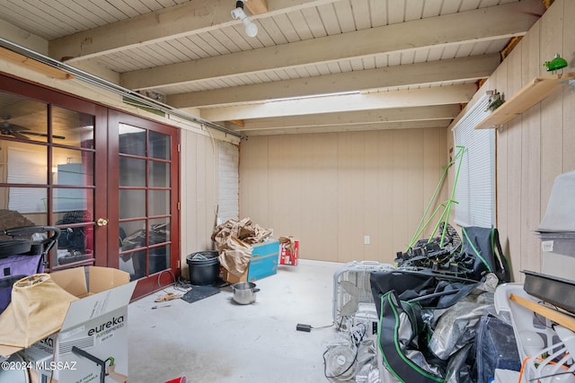 interior space featuring french doors and wood walls