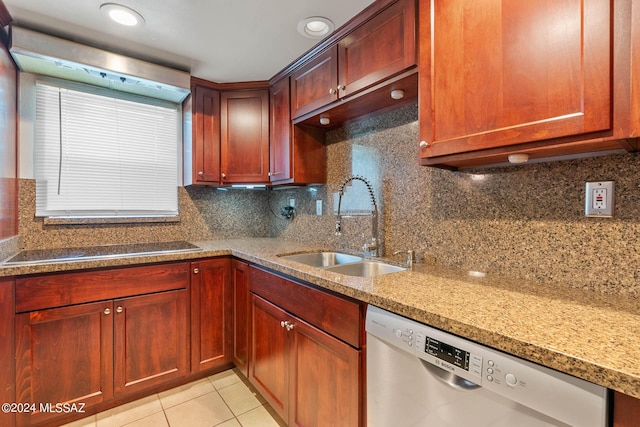 kitchen featuring decorative backsplash, dishwasher, a sink, light tile patterned floors, and light stone counters
