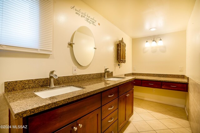 bathroom featuring double vanity, a sink, and tile patterned floors