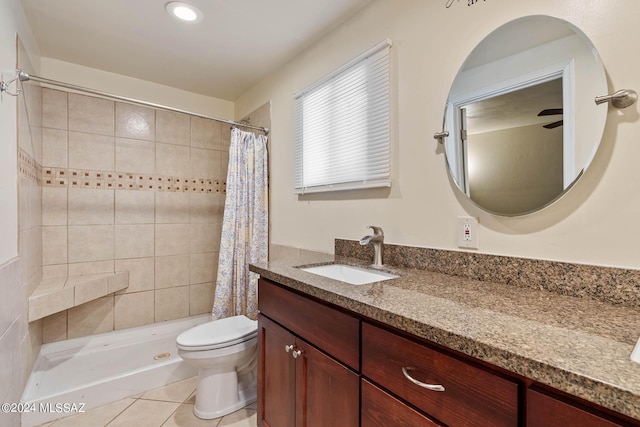 bathroom with vanity, tile patterned floors, toilet, and tiled shower