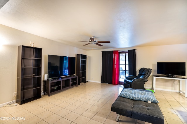 tiled living room with ceiling fan and a textured ceiling