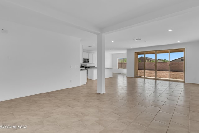 unfurnished living room featuring light tile patterned flooring