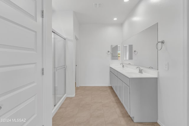 bathroom with tile patterned flooring, vanity, and an enclosed shower