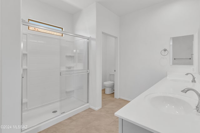 bathroom with tile patterned flooring, vanity, toilet, and an enclosed shower